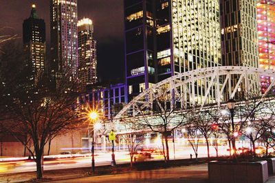 Illuminated city against sky at night