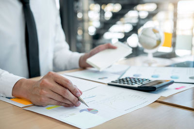 Cropped image of man working on table