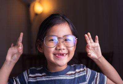 Portrait of smiling girl holding seashells