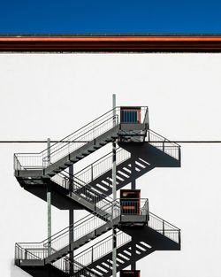 Low angle view of staircase against building against clear sky