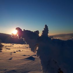 Scenic view of snow covered mountains against sky during sunset