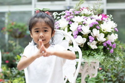 Portrait of cute girl with pink flowers