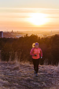 Woman running at dusk