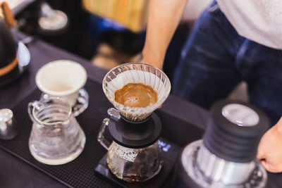 Close up drip coffee style brewing on top counter in cafe.