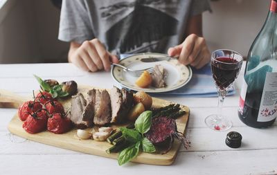 Close-up of hand with meal on table