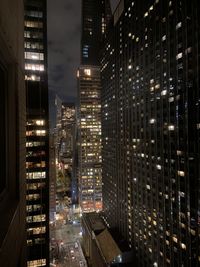 Illuminated modern buildings in city at night