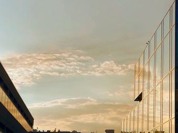 Low angle view of modern buildings against sky during sunset