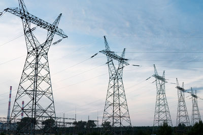 Low angle view of electricity pylon against sky