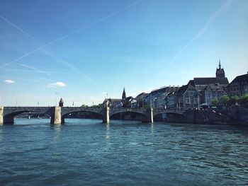 Bridge over river with buildings in background