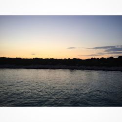 Scenic view of lake at sunset