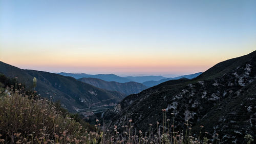 Scenic view of mountains against clear sky during sunset