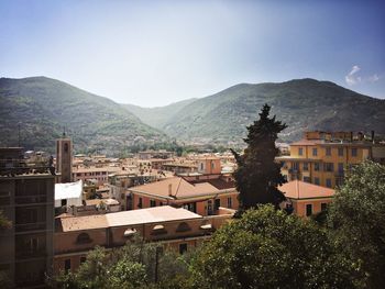 Buildings in town against sky