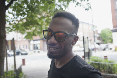 Portrait of smiling young man in city