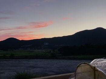 Scenic view of river against sky during sunset