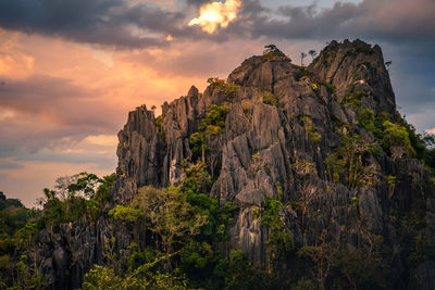 Low angle view of rock formation against sky during sunset