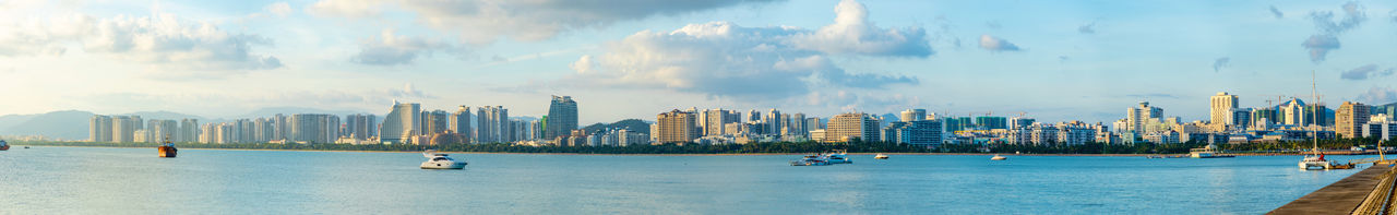 Panoramic view of sea and buildings against sky