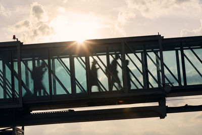 Silhouette bridge against sky during sunset