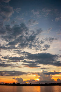 Scenic view of sea against dramatic sky during sunset