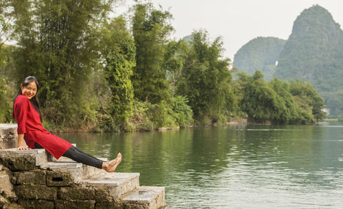 Beautiful woman sitting next to the river li in yangshuo