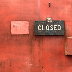 Close-up of information sign on wall