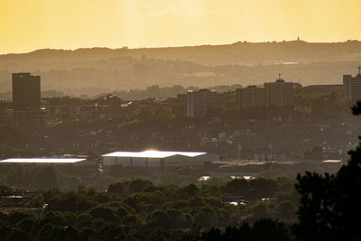 High angle view of buildings against sky during sunset