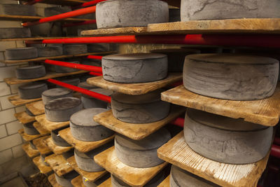Wheels of raw cow milk cheese age at creamery in hinwil, switzerland