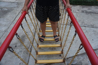 Low section of person standing on staircase in playground