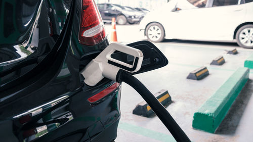 Fuel pump refueling car at gas station