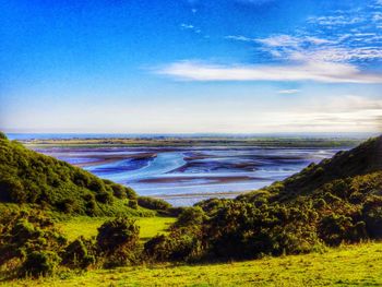 Scenic view of landscape against blue sky