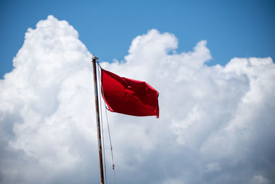 Low angle view of flag against sky