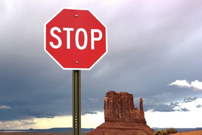 Road sign against sky