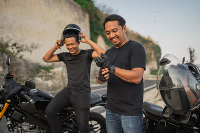 Portrait of young man riding motorcycle on road