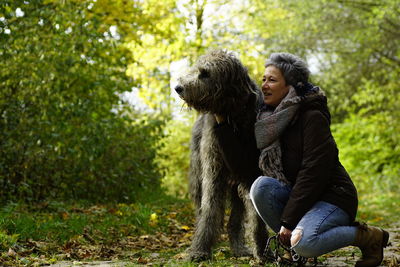 Woman with dog on field