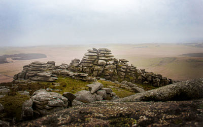 Rock formations on landscape against sky