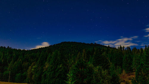 Scenic view of mountains against sky at night