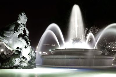 Close-up of illuminated fountain against sky at night
