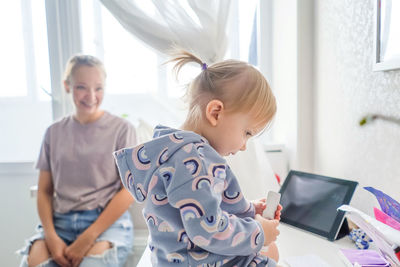 Siblings and woman at home