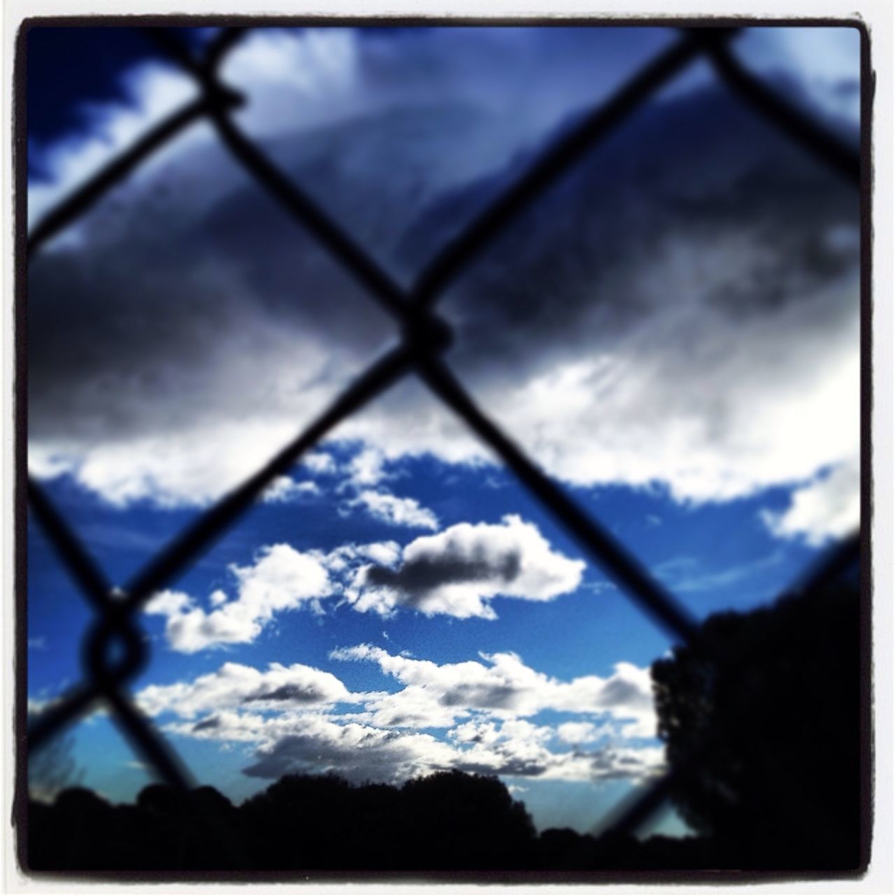 sky, transfer print, silhouette, cloud - sky, low angle view, auto post production filter, cloud, cloudy, tree, nature, dusk, outdoors, tranquility, no people, day, beauty in nature, overcast, focus on foreground, branch, weather