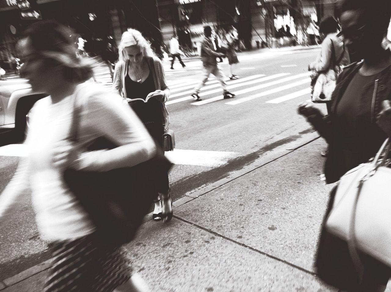 street, lifestyles, transportation, men, city life, person, land vehicle, leisure activity, road, city, car, mode of transport, walking, casual clothing, city street, large group of people, on the move, zebra crossing, sunlight