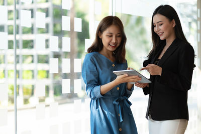 Portrait of young woman using mobile phone