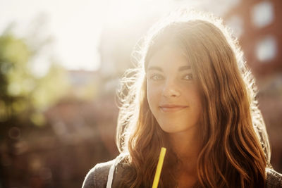 Portrait of smiling teenage girl outdoors