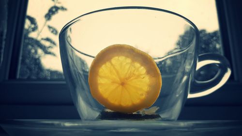 Close-up of lemon on glass