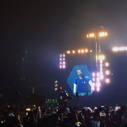 People enjoying music concert at night