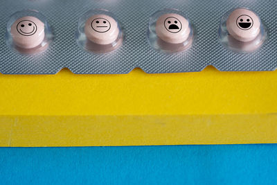 Close-up of anthropomorphic faces on blister pack