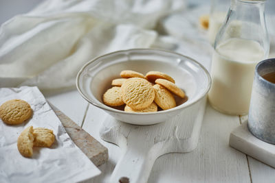 High angle view of cookies by milk in bottle on table