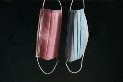 Close-up of clothespins hanging against black background