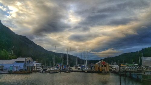 View of harbor against cloudy sky