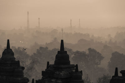 Historic building against sky during foggy weather