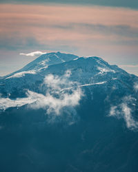 Aerial view of snowcapped mountains against sky