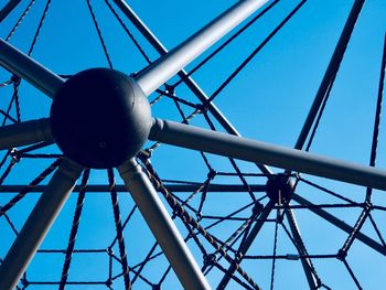 Low angle view of outdoor play equipment against clear blue sky